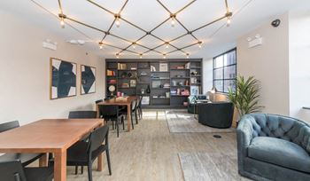 A modern dining room with a wooden table and chairs.